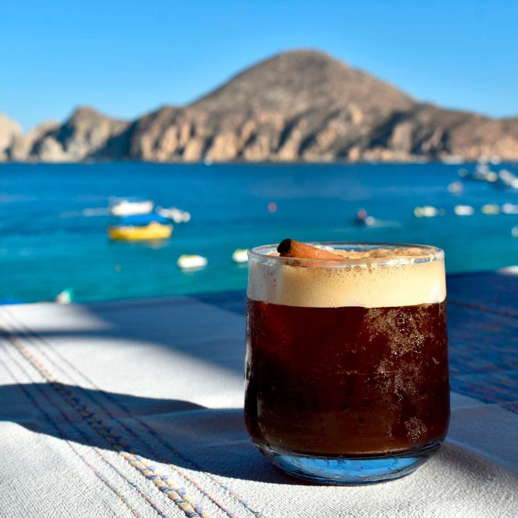 Cocktail with a view of the Arch at Mango Deck, Medano Beach